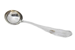 Smooth silver soup ladle with grooves along the handle