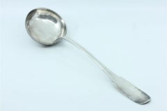 Smooth silver soup ladle with grooves along the handle to be shipped