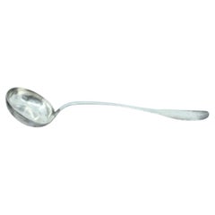 Smooth silver soup ladle with grooves along the handle to be shipped