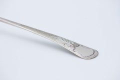 Smooth silver soup ladle with guilloche handle and monogrammed plate