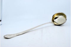 Smooth silver soup ladle with raised grooves along the handle