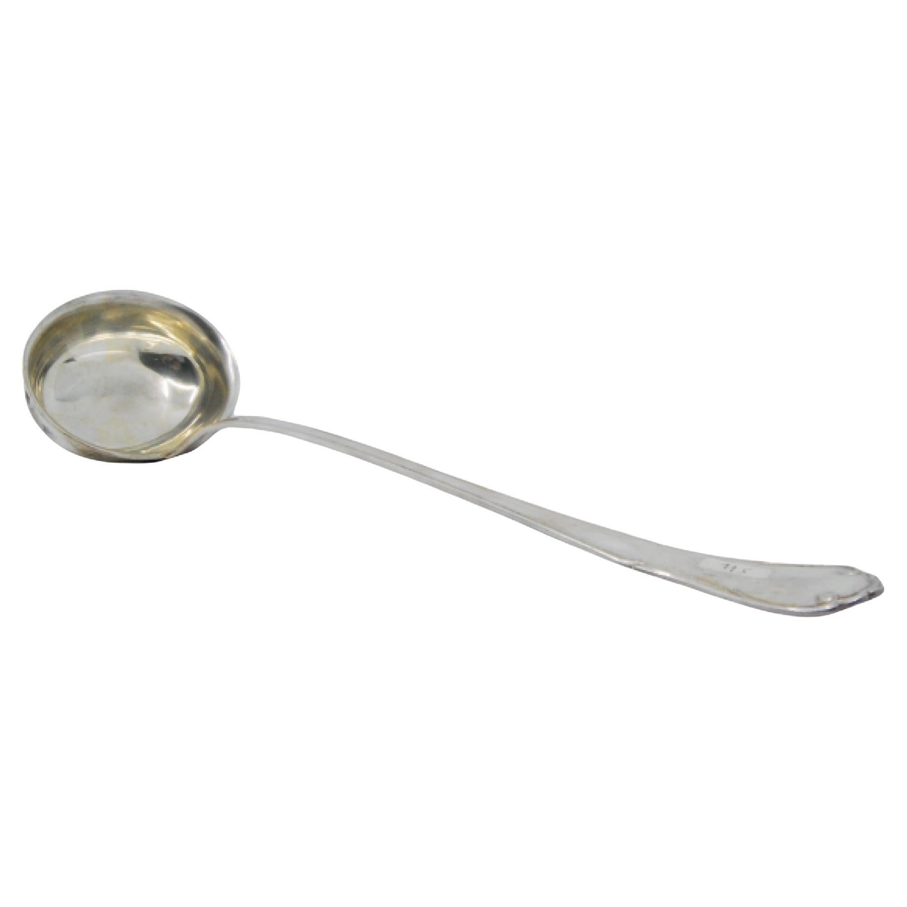Smooth silver soup ladle with raised grooves along the handle