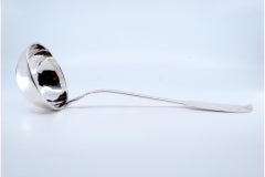 Smooth silver soup ladle with relief on the handle