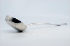 Smooth silver soup ladle with relief on the handle