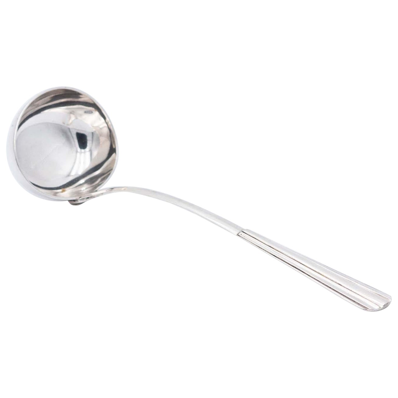 Smooth silver soup ladle with reliefs along the handle
