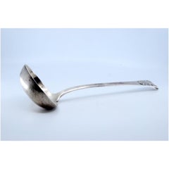 Smooth silver soup ladle with reliefs on the handle