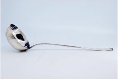 Smooth silver soup ladle with small relief on the end of the handle