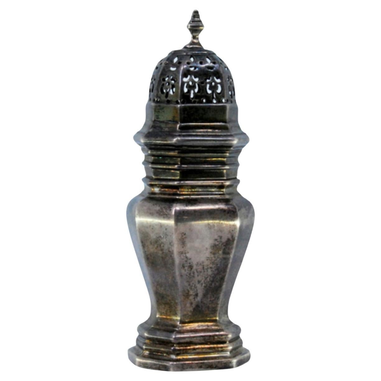 Smooth silver sprinkler with octagonal shape and friezes around the edges