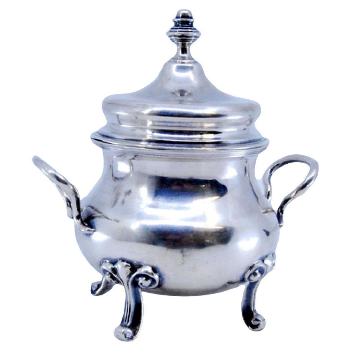 Smooth silver sugar bowl resting on four zoomorphic feet