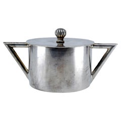 Smooth silver sugar bowl with a rubber knob on the lid and geometric handles