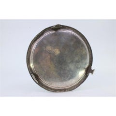 Smooth silver tray with pearly rim and resting on three raised feet