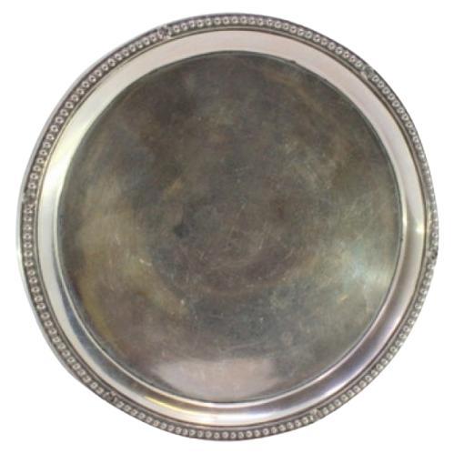 Smooth silver tray with pearly rim and resting on three raised feet