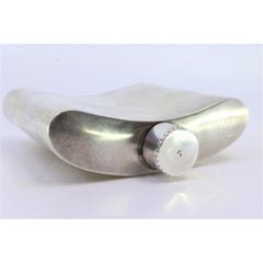 Smooth silver whiskey flask with a fluted, curved lid