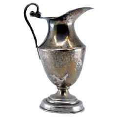 Smooth silver wine jug set on a beaded base