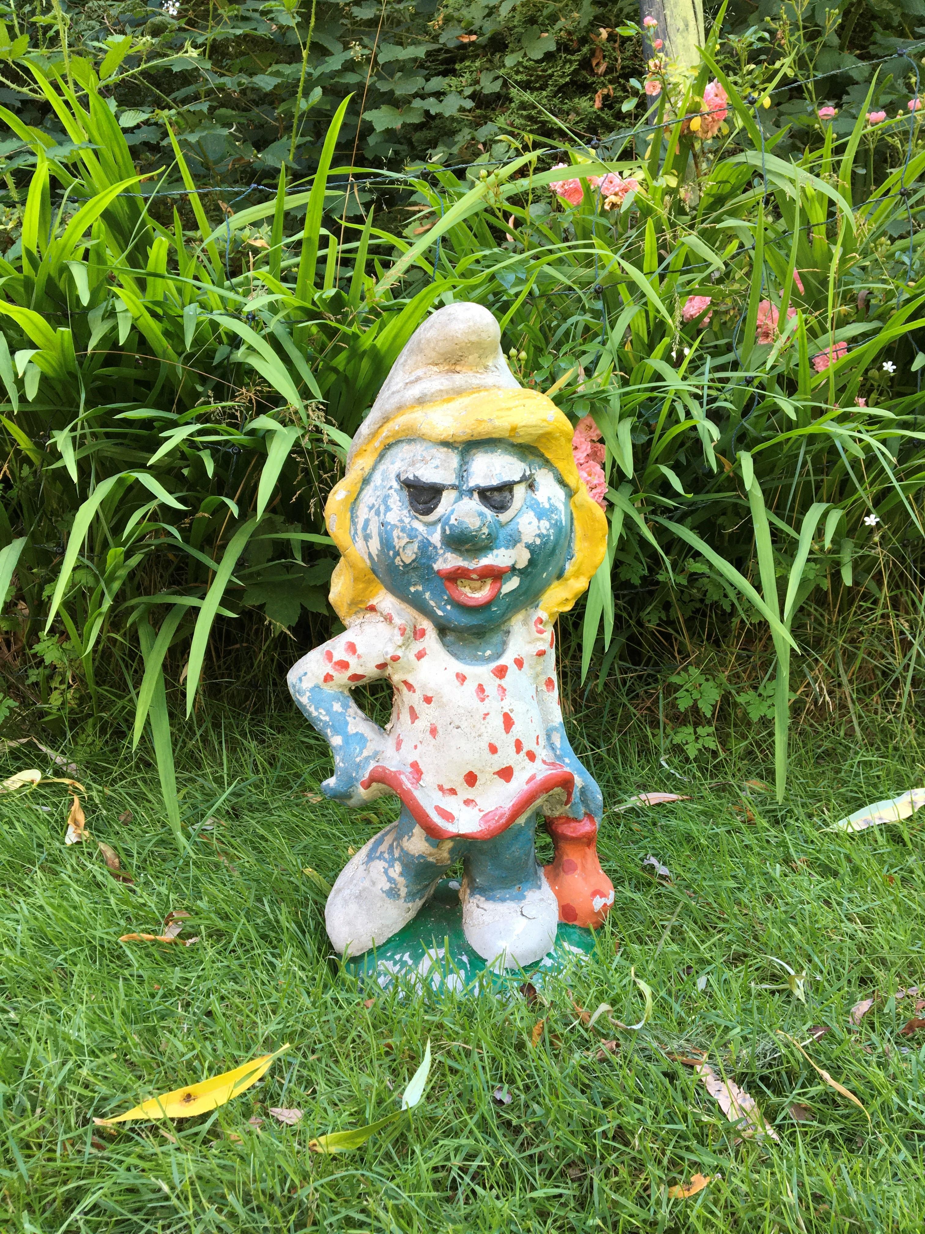 Concrete Smurfette garden statue.
Smurfette is known from The Smurfs; she was the first female smurf in smurf village. A character created by Peyo and in the story created by Gargamel.

A decorative statue for a collector and fan of The Smurfs.