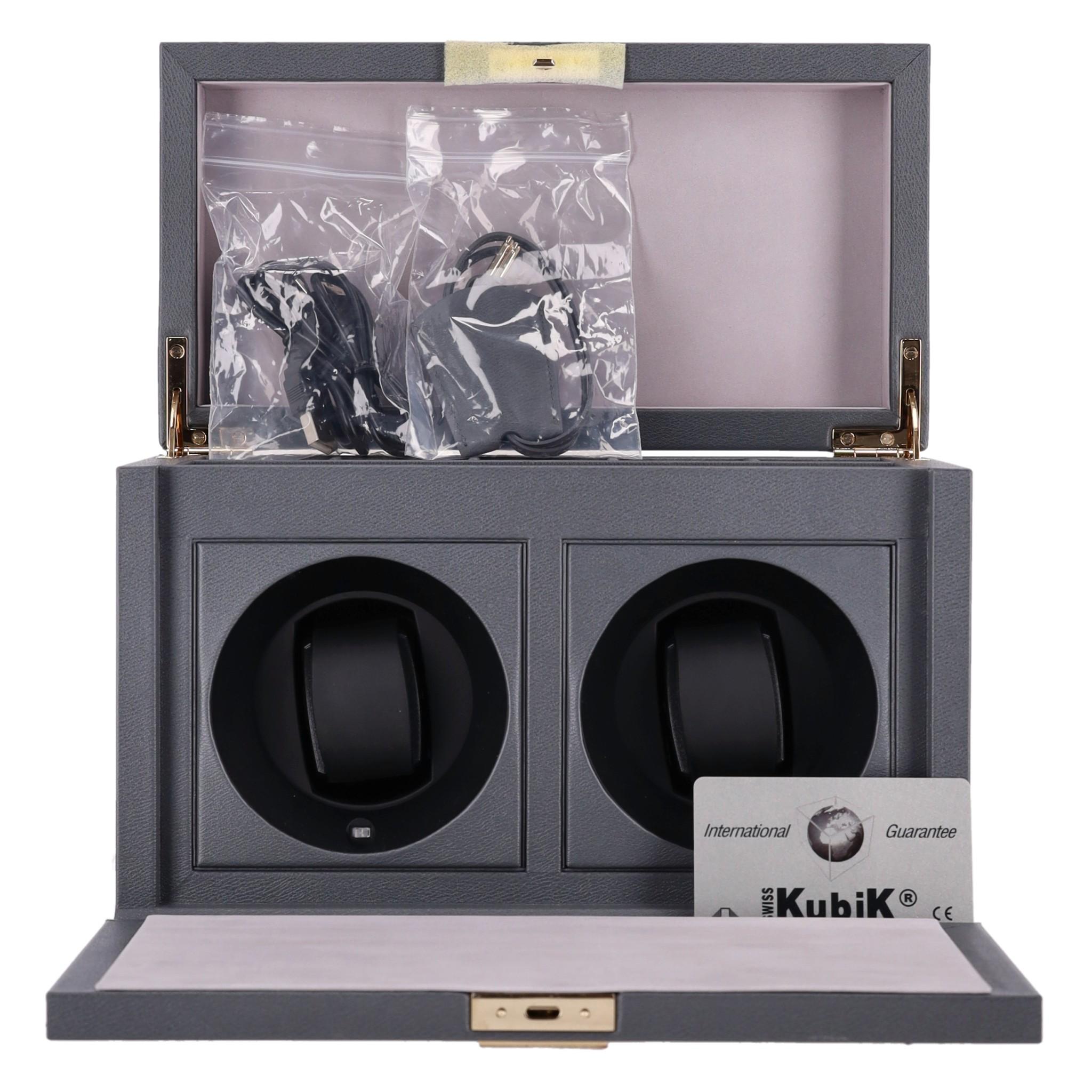 Smythson Grosvenor Leather Rotary Watch Box 

Grey calf leather watch box with fold-down magnetic front flap.

Two watch compartments with Swizz made battery operated rotary mechanism 

to keep the watches fully wound when not in use as well as five