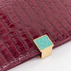 SMYTHSON Mara burgundy croc embossed high gloss teal clasp passport cover