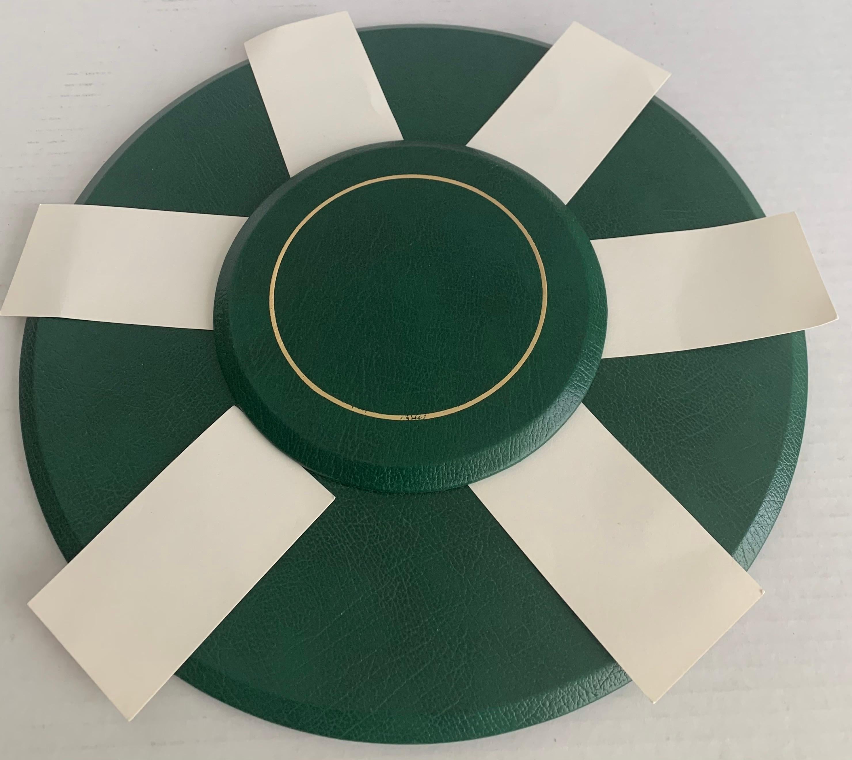 Smythson of Bond Street green leather round table seating chart. Classic racing green leather with gold embossed detailing. Included 6 ecru paper name cards. Underside is black leather stamped Smythson of Bond Street.
Comes with original retailer