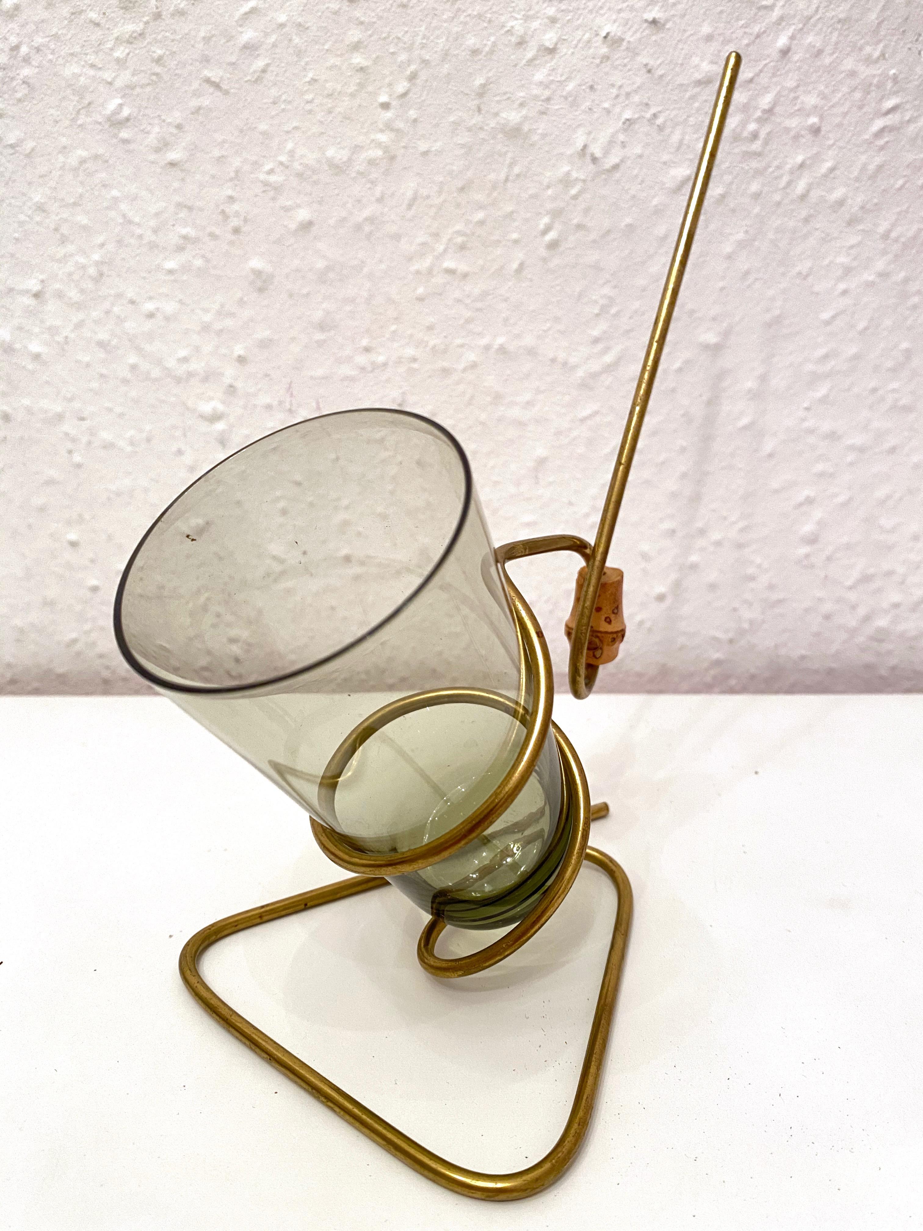 This lovely piece is typical 1950s. The glass is for salt sticks or nuts and the golden metal stand is for pretzels.
The handle is made of bamboo. The glass is smoked grey and the metal holder is in gold with some patina.
The set is in very good