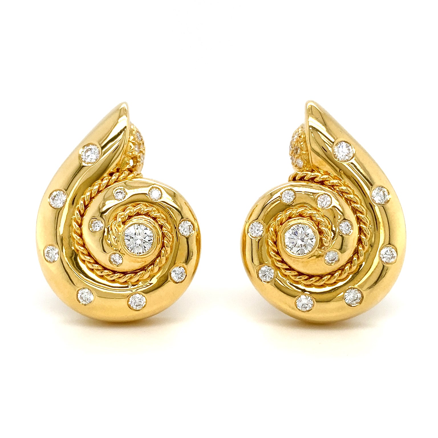A glimmering aquatic look is achieved by these polished 18k yellow gold snail earrings. Round brilliant cut diamonds are bezel set throughout for added luster. In the center is a larger diamond. The braided spiral within, traces the curve for added
