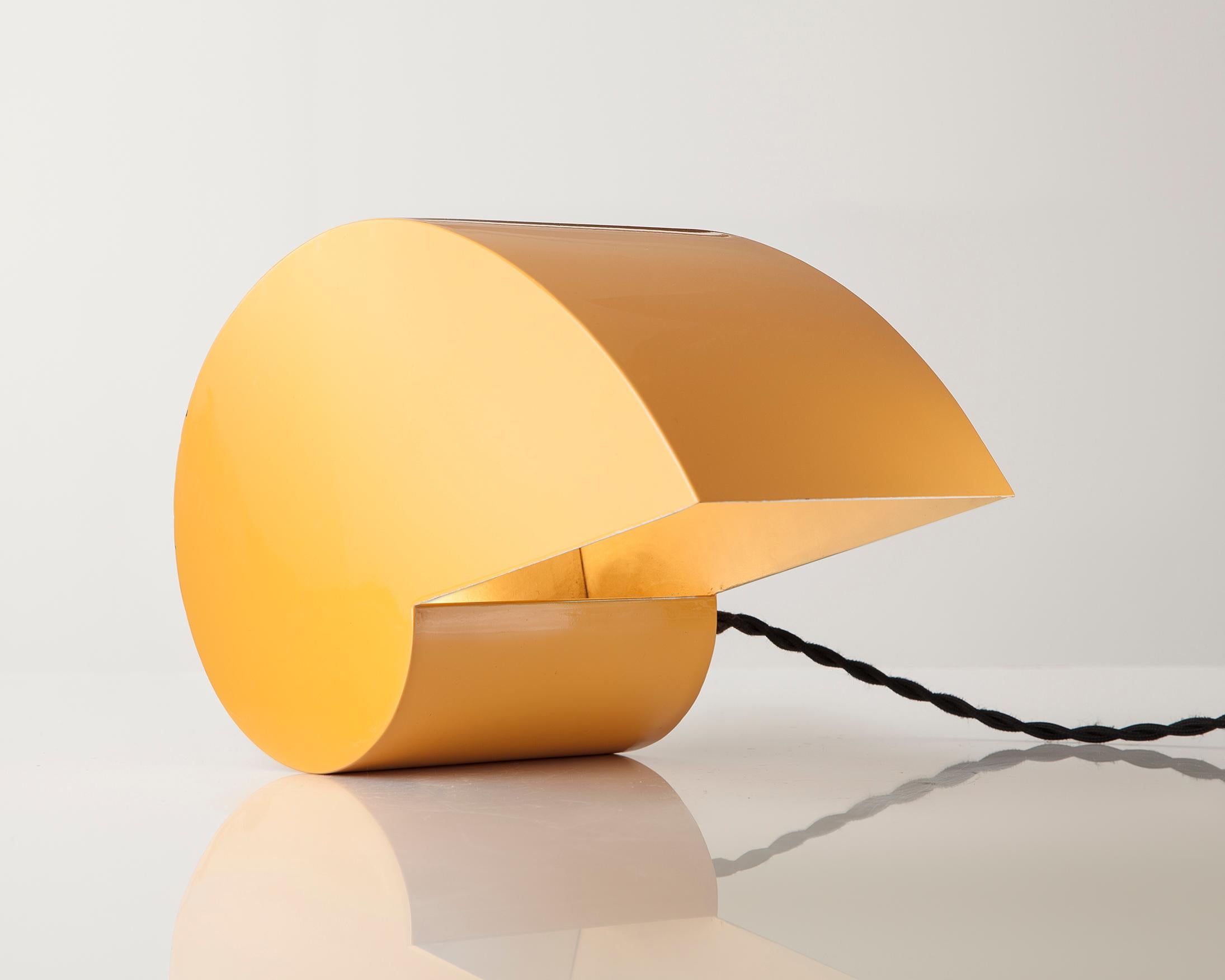 The snail table lamp in yellow lacquered metal. Designed by G. Raimondi for Studioluce, Italy, circa 1970.
  