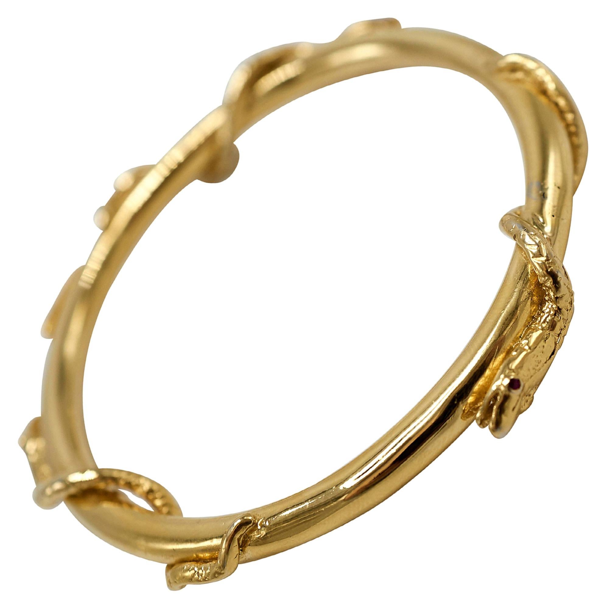 Snake Bangle 14 k Gold Bracelet Emerald Ruby Blue Sapphire J Dauphin

J DAUPHIN Bangle Arm Cuff with 3 snakes  in solid 4k Gold weighs around 40 gram.

Historically, serpents and snakes represent fertility or a creative life force. As snakes shed