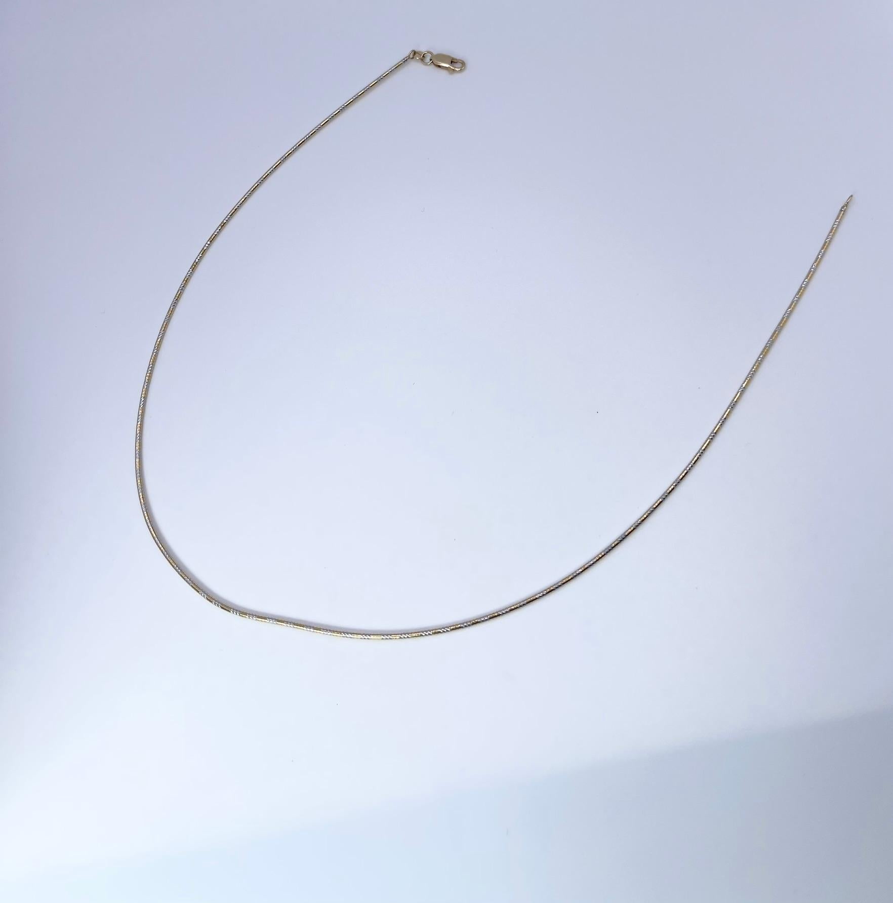 Snake gold chain 14KT white and yellow gold, plain solid chain 18 inches.

GRAM WEIGHT: 7.16gr
GOLD: 14KT gold
CLOSURE: Lobster
WIDTH: 1.5MM
LENGTH: 18