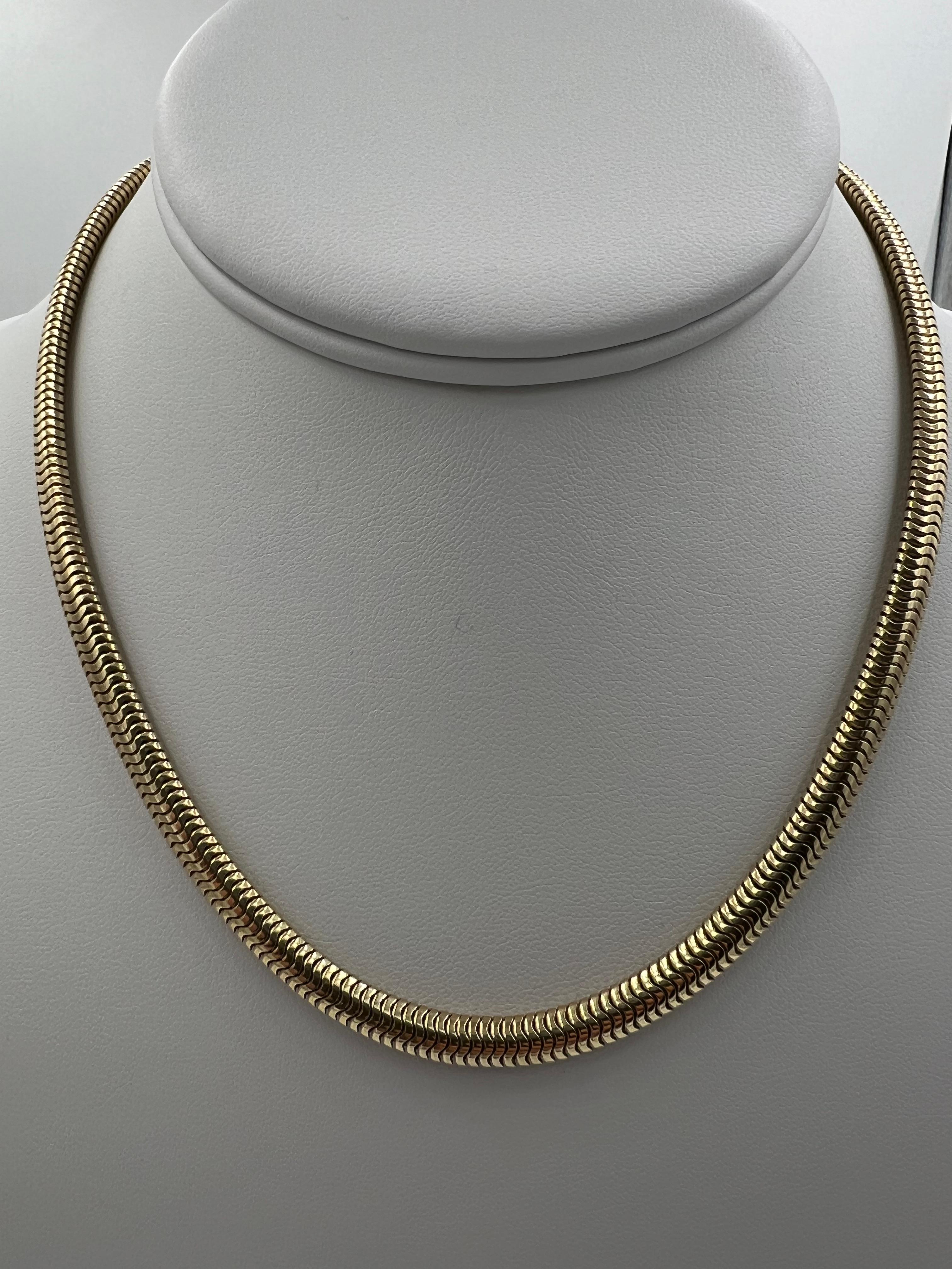 Snake chain yellow gold necklace, circa 1950s. 
  This vintage snake chain yellow gold necklace is a timeless piece of jewelry. Crafted from luxurious 14k yellow gold, this necklace features a unique oval snake chain design which can be worn alone