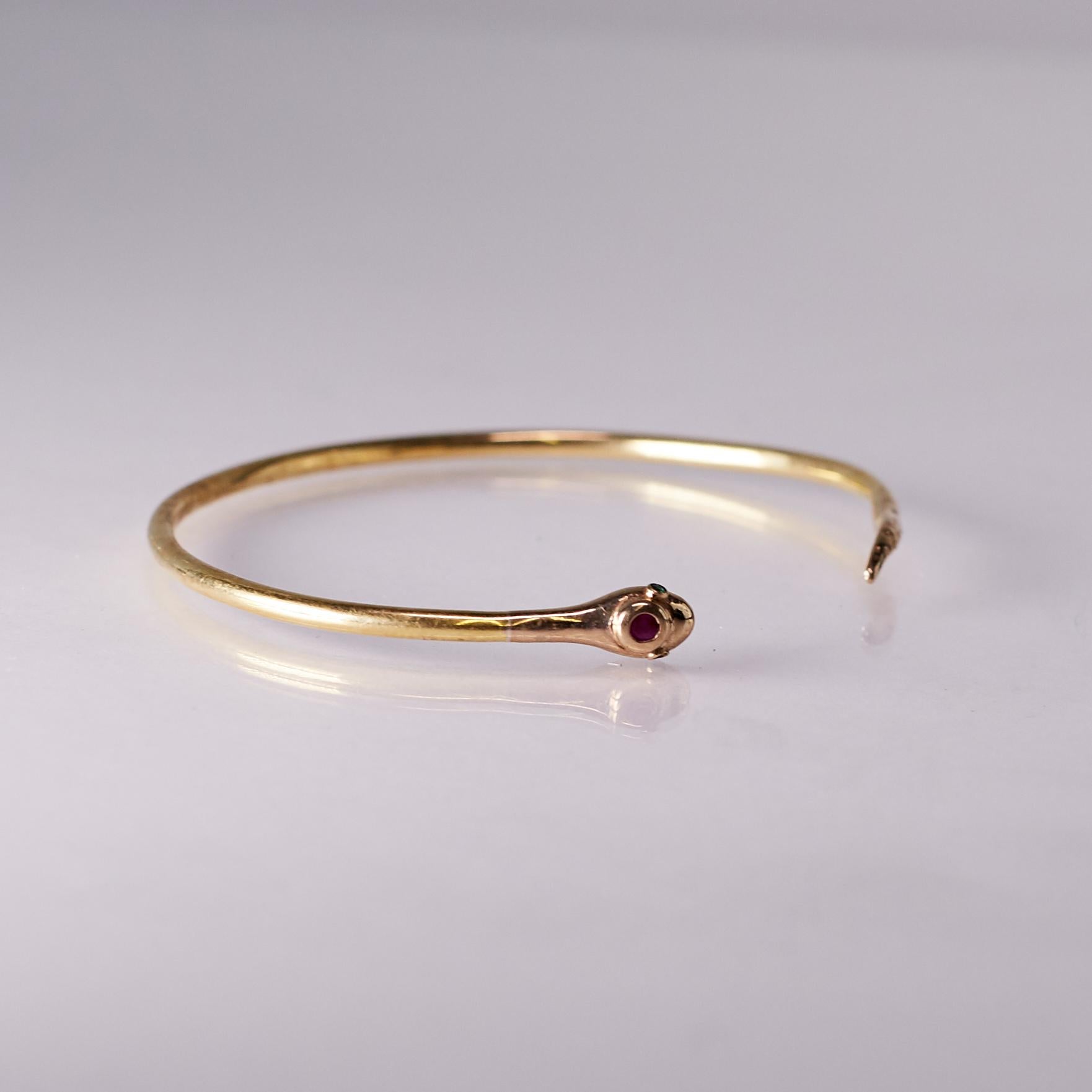 Snake bracelet bangle in 14k Gold Plate with emerald eyes and ruby on the head, designed in a Victorian style. 

Made to order. Completion 4 weeks. 

The snake is a symbol of transformation, renewal, and protection. In jewelry, it represents wisdom,