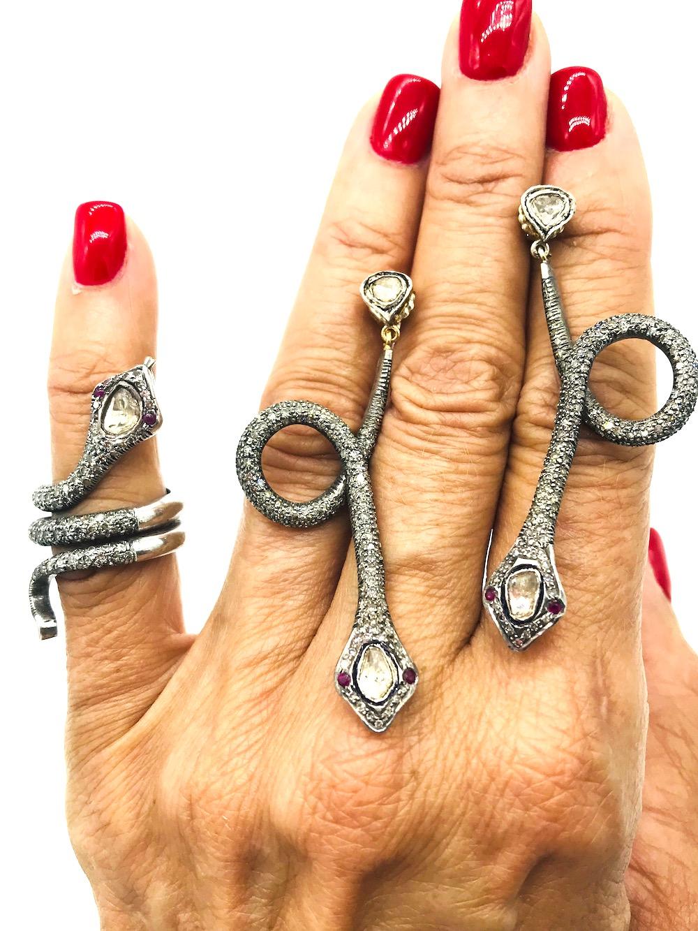 Snake Earrings and Ring, Circa 18th Century, Silver-Diamonds 
Matched set of snake jewelry. The ring is a triple, Size 6 shank expanding 40 mm from tip of head to the tail. The 150 diamonds are encrusted in prongs measurig 1.50-1.60 mm each. The