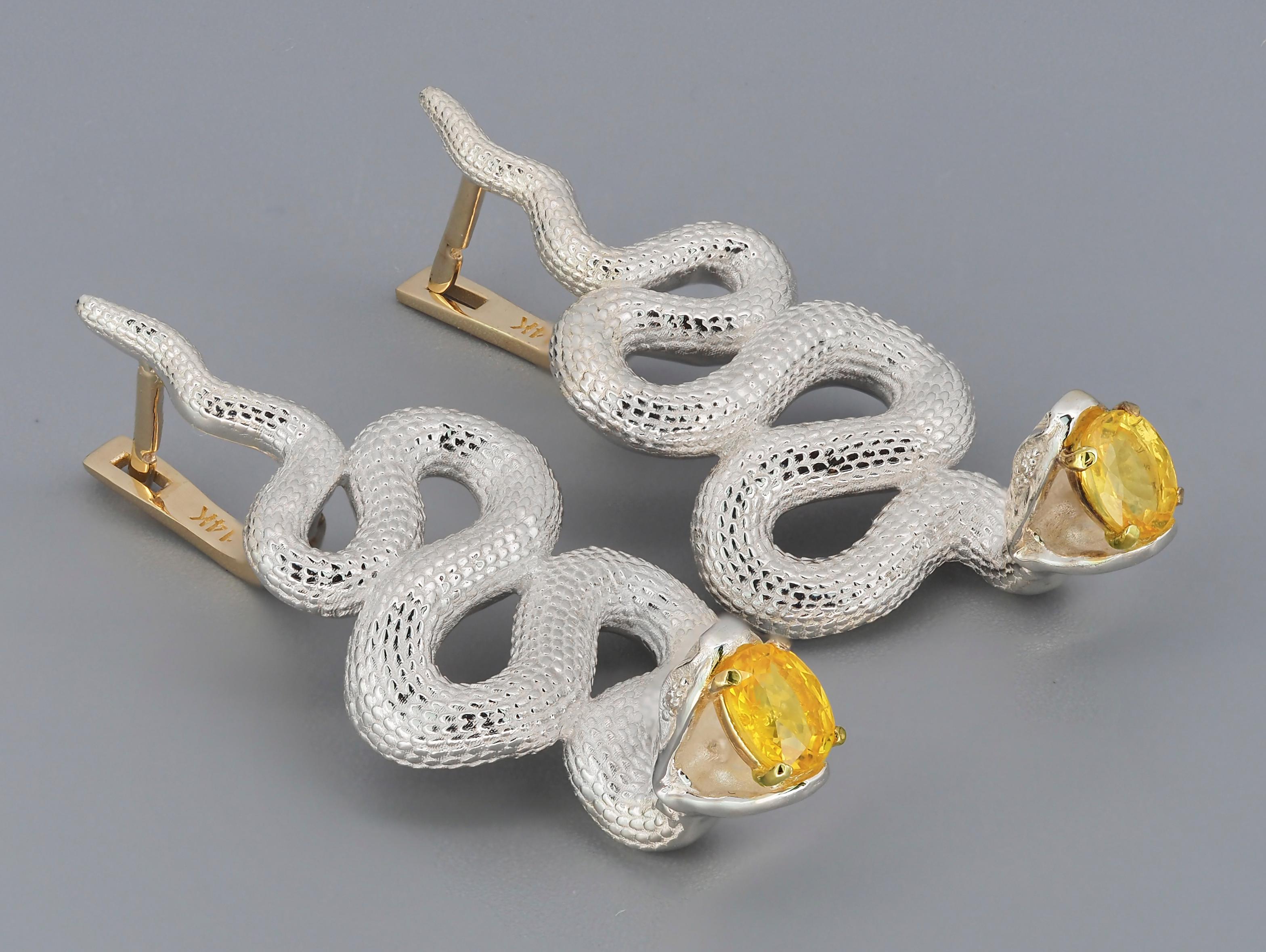 Snake earrings. 
Genuine yellow sapphires earrings. Two metal earrings: gold, silver. Serpent Earrings for Women Large.

Earrings are made with two material: 14 kt yellow gold (1.3 g) - clasp and 925 purity silver - other parts - 12 gr.
Total