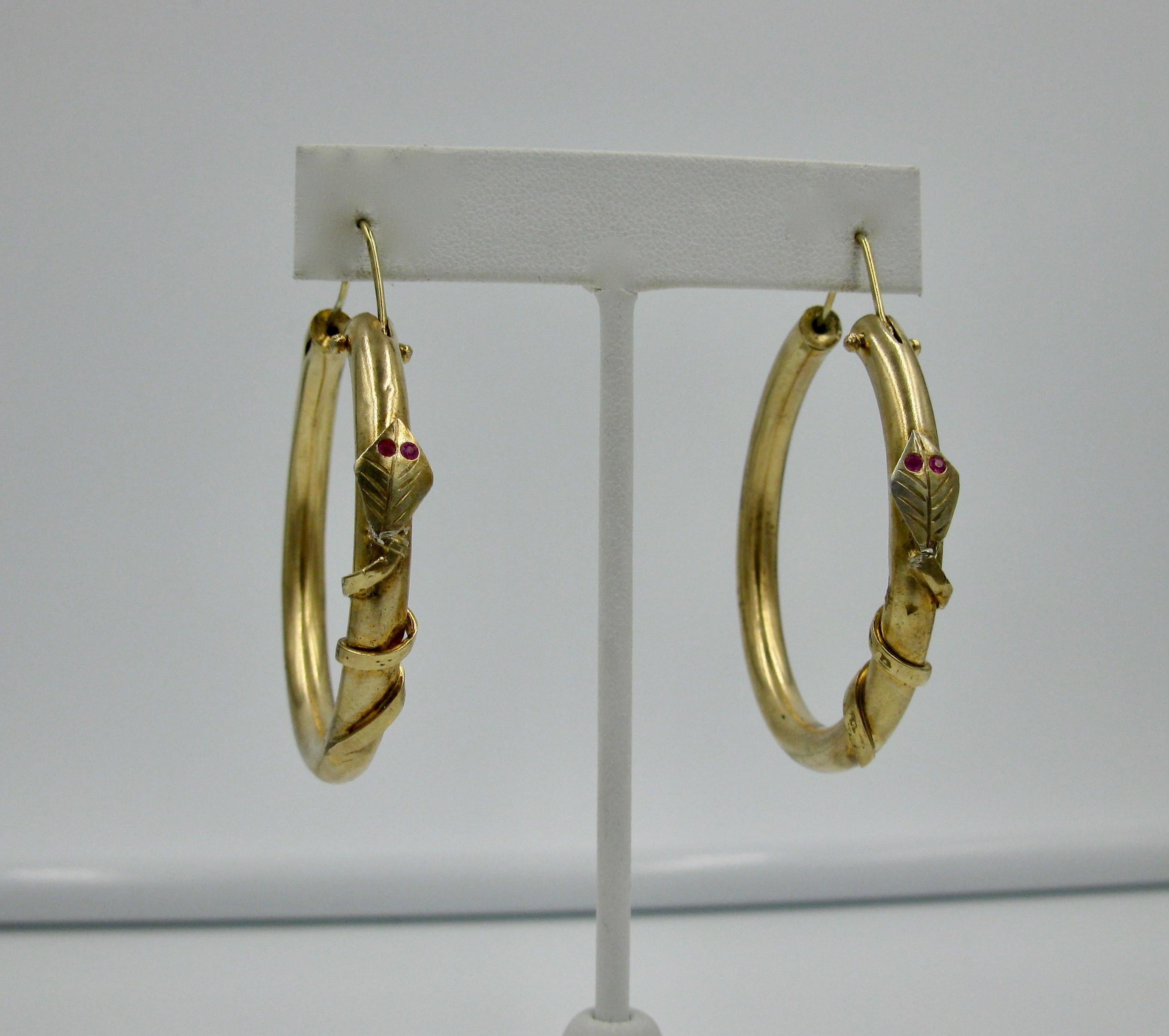 A rare pair of Snake Earrings - museum quality Etruscan Revival Victorian Hoop Earrings with entwined snakes with Ruby eyes.  The earrings of Italian Tuscany origin, probably Florentine, in 12 Karat gold, as the early Italian jewels were, with round