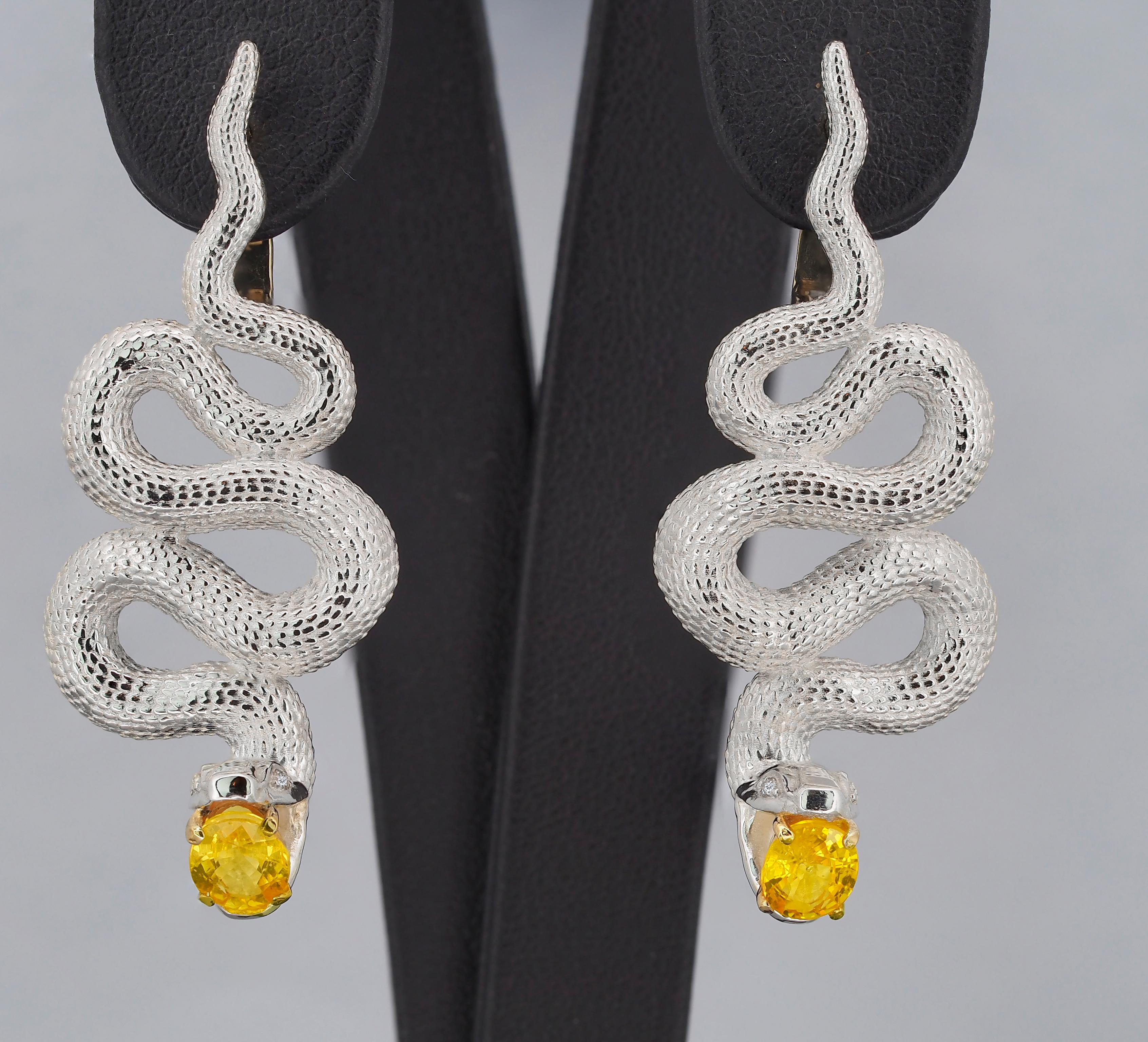 Massive Snake earrings with natural sapphires in opened mouth and diamonds in eyes. September birthstone. 

Earrings are made with two material: 14 kt solid yellow gold (1.3 g.) - clasp and 925 purity silver - other parts - 12 g.
Total weight: 13.3