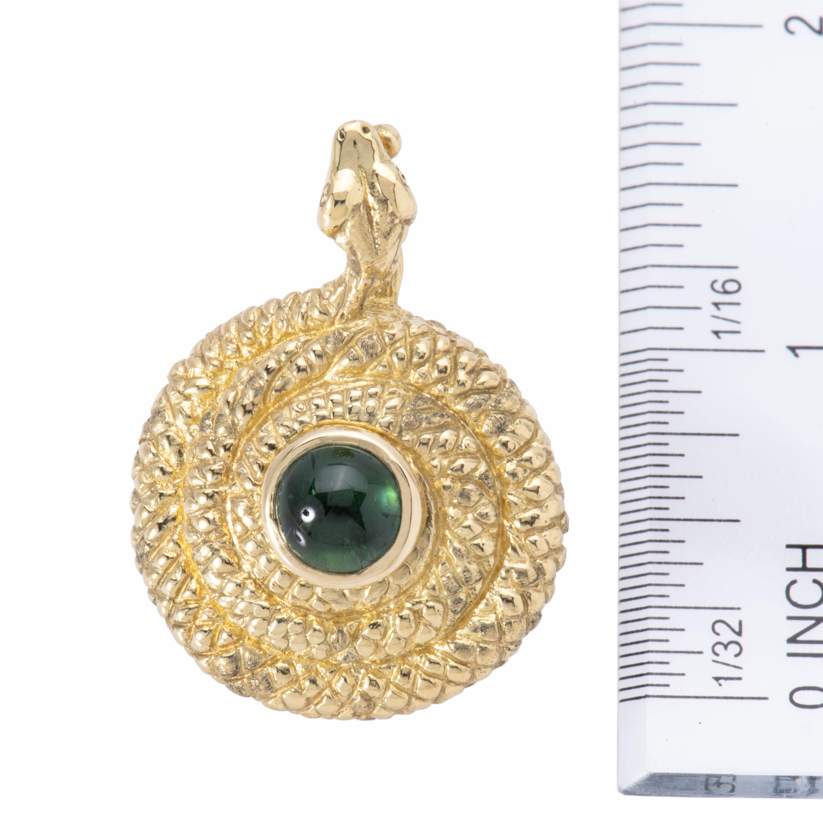 Conjure ancient mysteries of desert sands with this snake locket pendant embellished with 2.22cts of glowing, green tourmaline cabochon. Handcrafted entirely of 18k gold, the bail is comprised of the snakes's head and the body winds around to form a