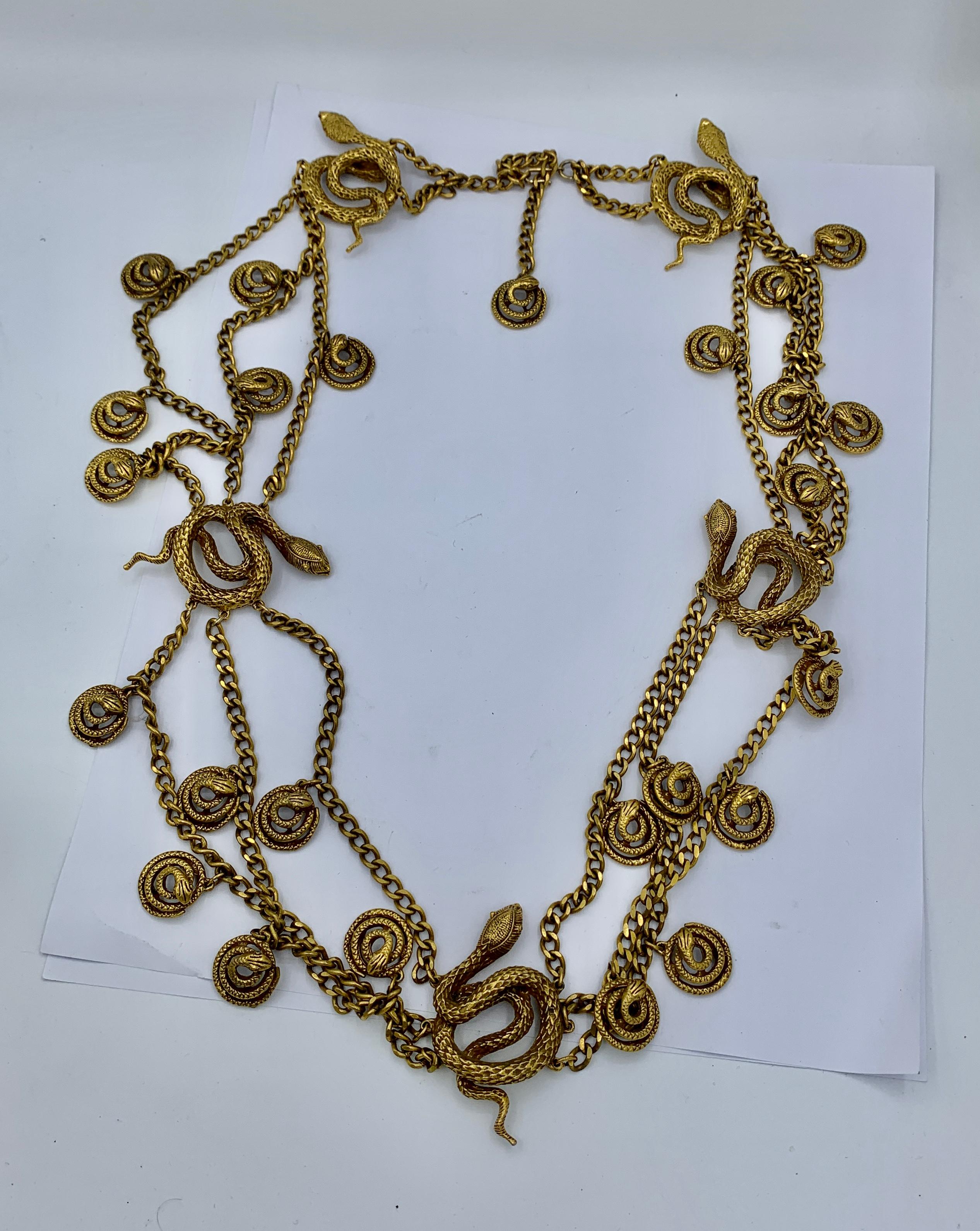 This is a fabulous and dramatic Snake Necklace or Belt in Goldtone metal.  The extraordinary necklace dates to the Mid-Century period and is a multi-strand necklace or belt of 32 inches in length.  The necklace or belt length is adjustable as the