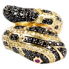 Snake ring in 18-carat yellow gold decorated with 86 black diamonds and 2 rubies