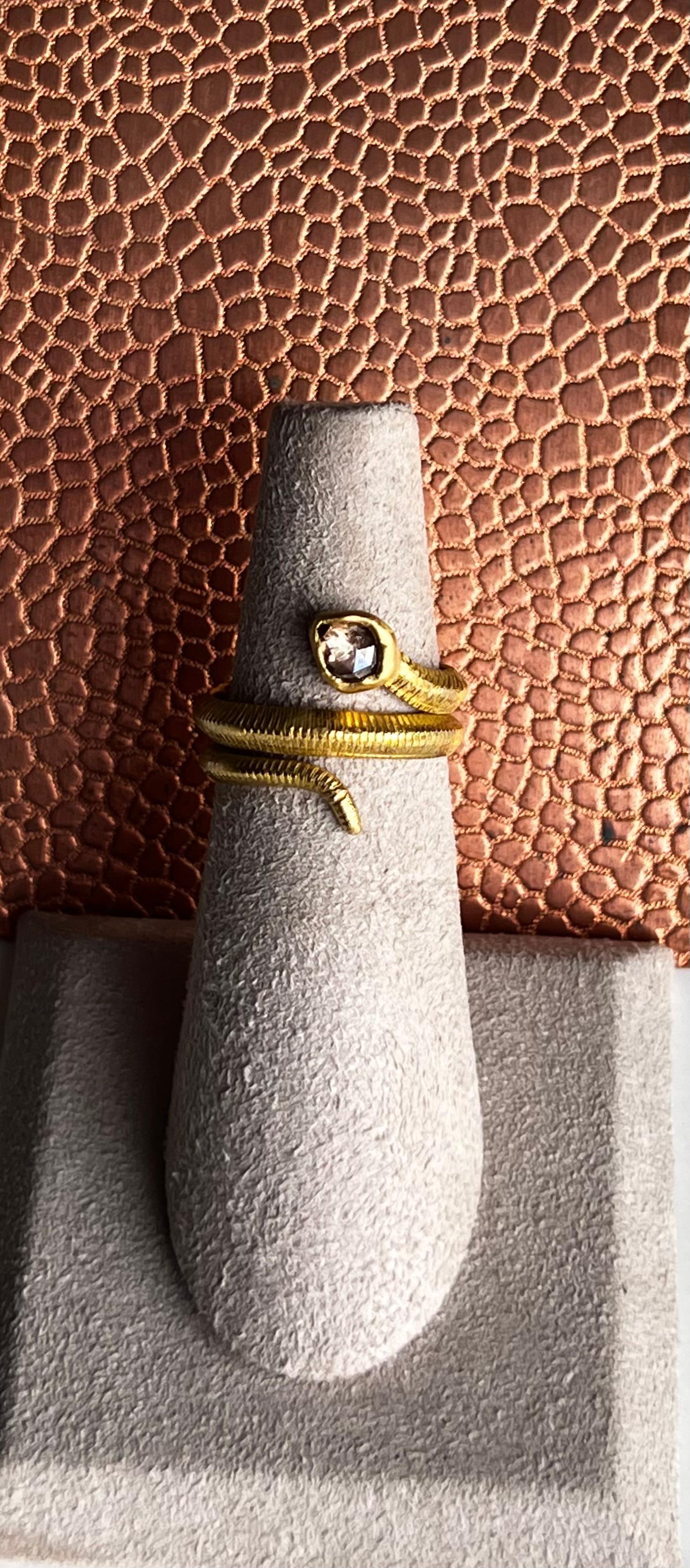 This ring is entirely hand crafted with cognac diamond in lieu of the head of the snake and an engraved texture for the scales. The rich yellow color of 20 karat gold enhances the contrast with the cognac rose cut diamond and is reminiscent of