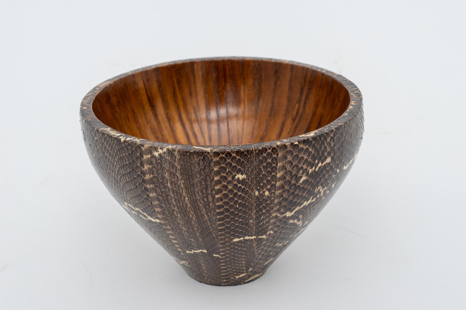 This stylish and chic vase has an interior of mahogany with an exterior wrapped in snake skin and it was created by R&Y Agousti in the 1990s.