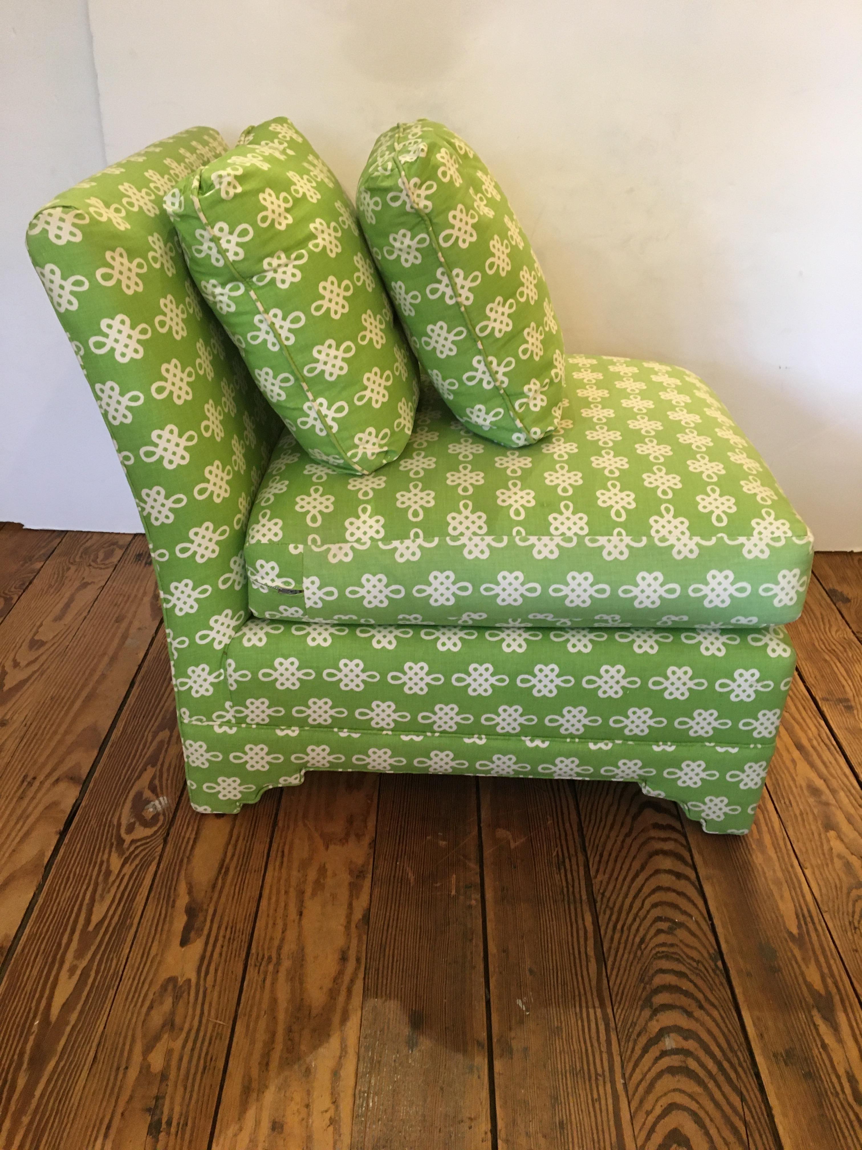 Vintage pair of bright green cotton print slipper chairs with upholstered Moorish arched foot, loose seat cushion, and two throw cushions. Good condition overall, but some very light fading. 