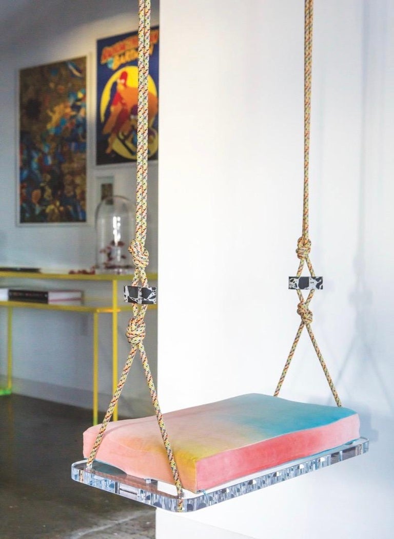 The Sno-Cone swing is a playful indoor swing featuring a hand dyed multi-color velvet cushion, colorful accessory cord, a Lucite base and Lucite accessories created in collaboration with artist and clothing designer, Christopher Thomas of Three