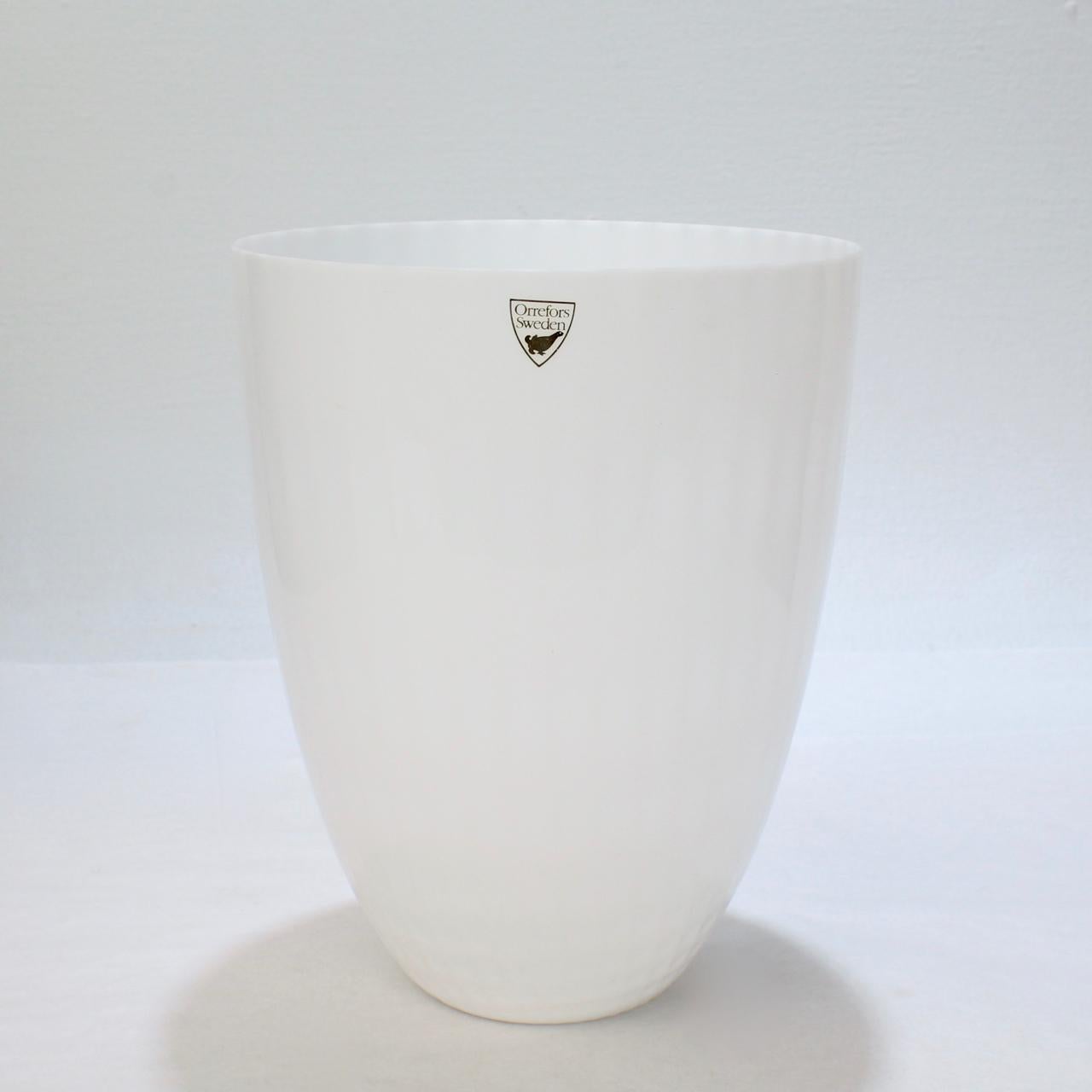 A fine art glass vase by Orrefors. 

Entitled Snöljus or Snowlight.

Designed by Ingegerd Råman.

Together with its Orrefors box.

Bearing an etched signature to the base: Orrefors.

Date:
Late 20th Century

Overall Condition.
It is in overall very