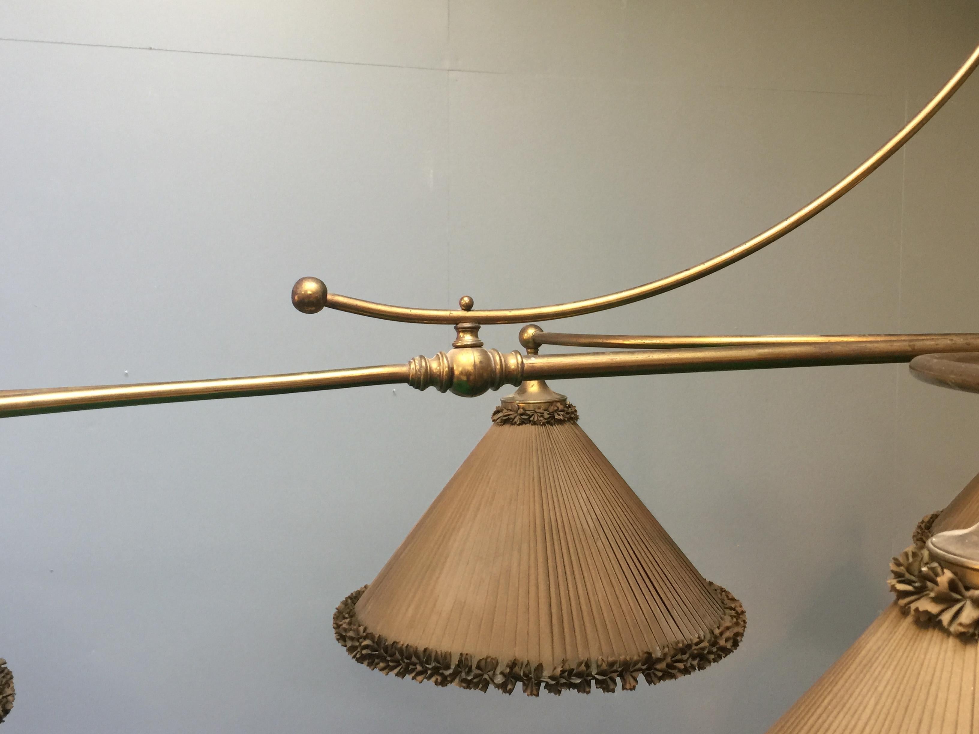 This brass framed billiard lamp is an original period piece, circa 1890, it is of elegant design and features eight hand made silk shades, the sweeping arched form is exceptionally rare, the shades are original to the lamp and are in good useable