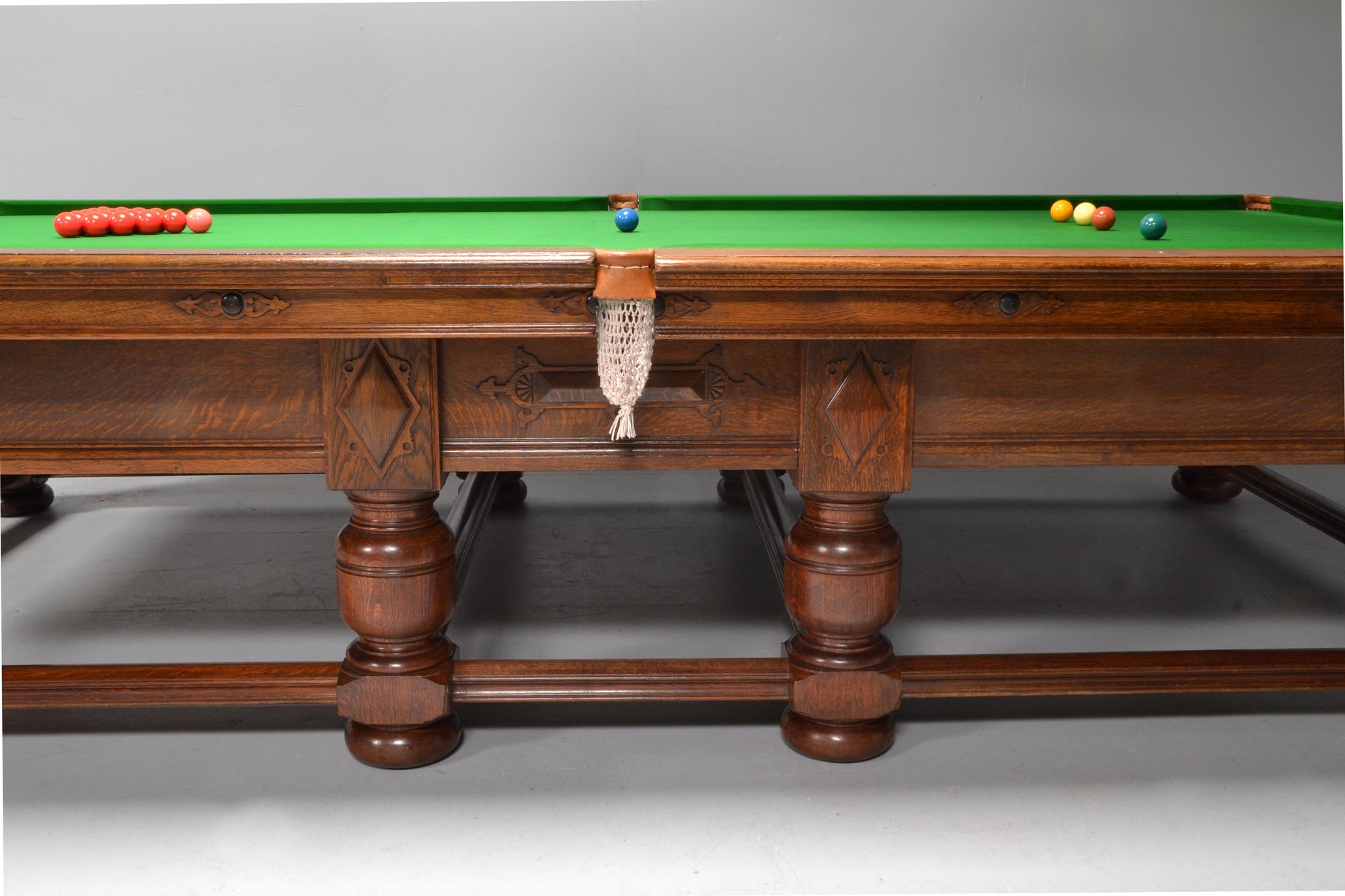 A rare solid oak full size billiard or snooker table of refectory or Jacobean form by the 