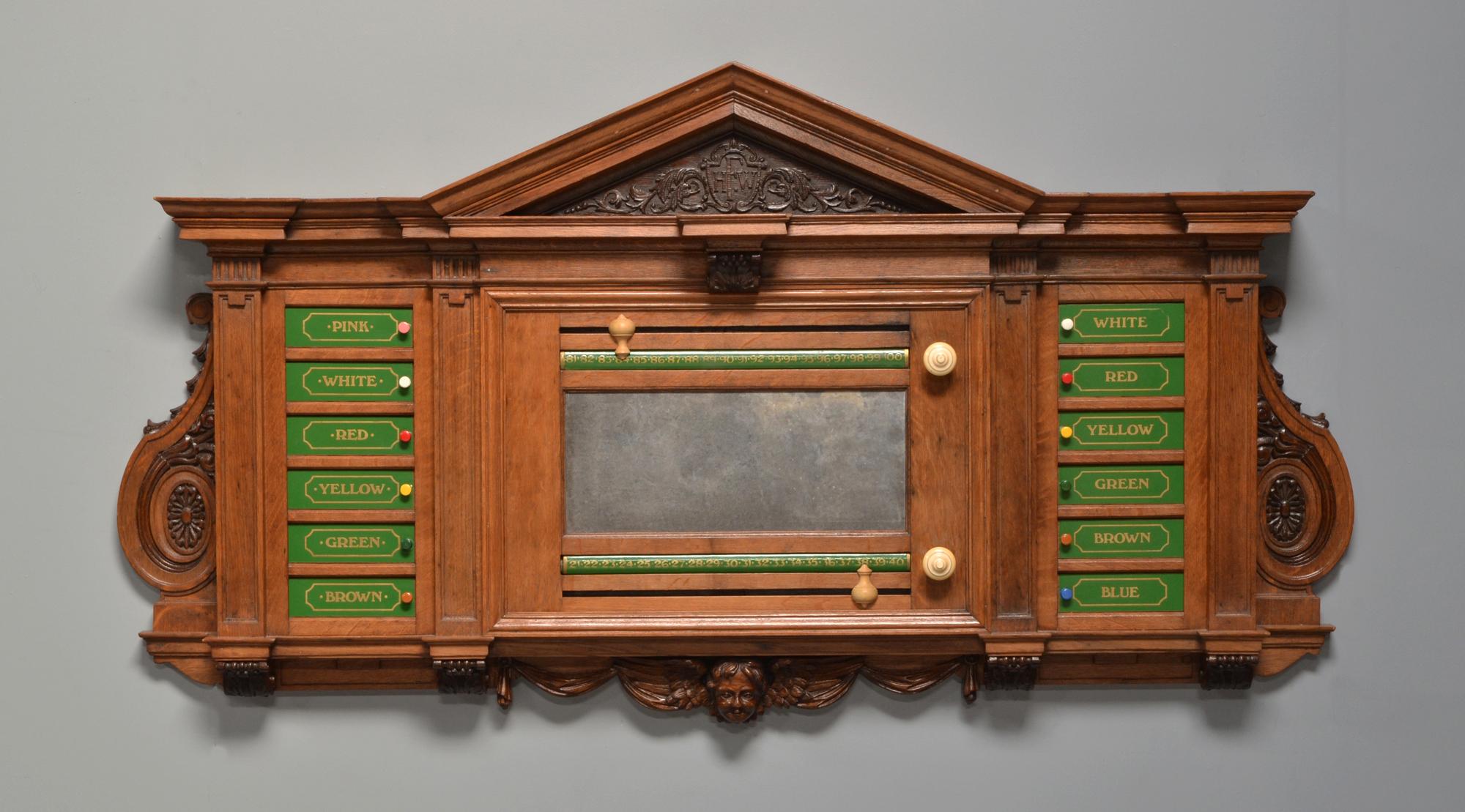 A very rare decorative scoring board circa 1890 featuring a carved cherub, almost certainly a commissioned piece.

Constructed from English oak with equisite detailing.

Rectangular form with classical upright columns flanked by carved