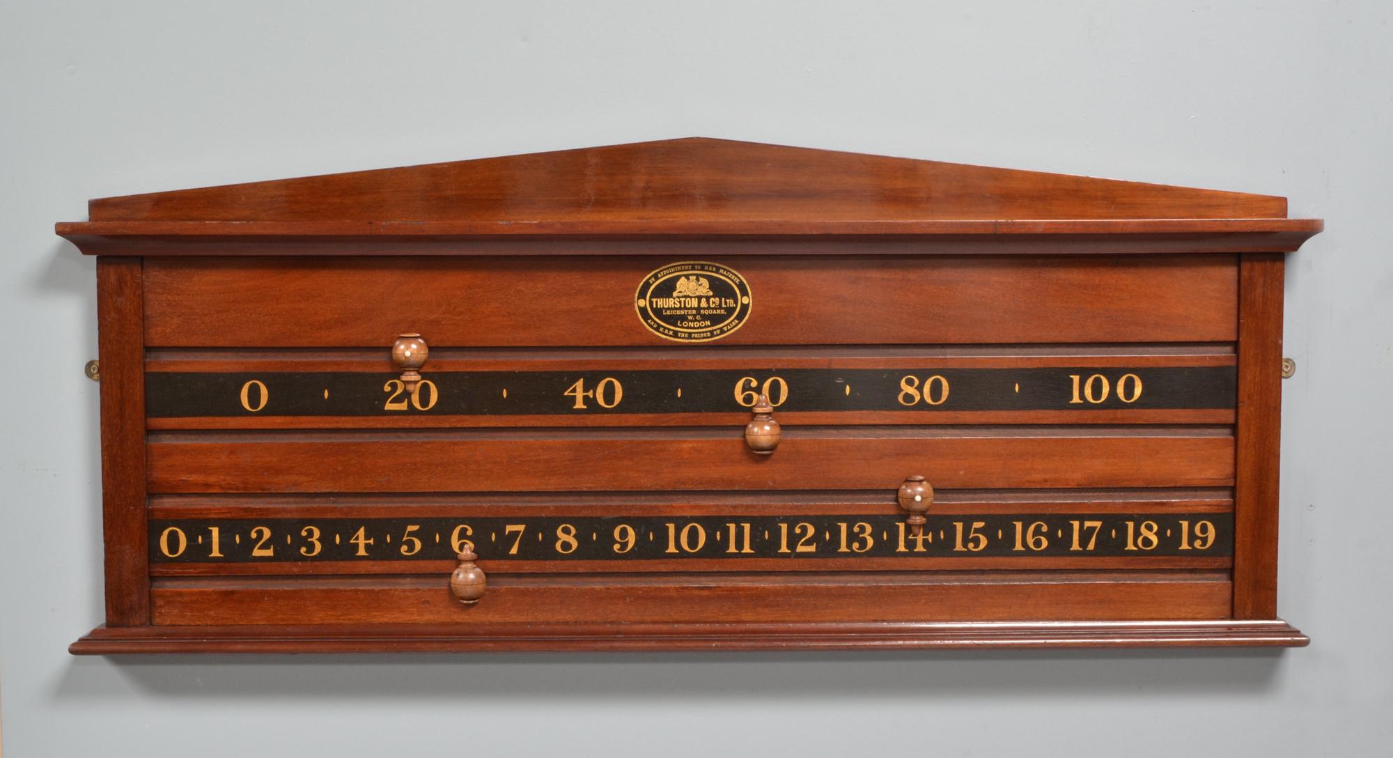 A mahogany framed billiards or snooker scoring board by Thurston of London circa 1895 with a shaped pediment.
A very nice cut of mahogany with boxwood sliding markers allowing each player to score up to 119 points.
The original makers transfer is