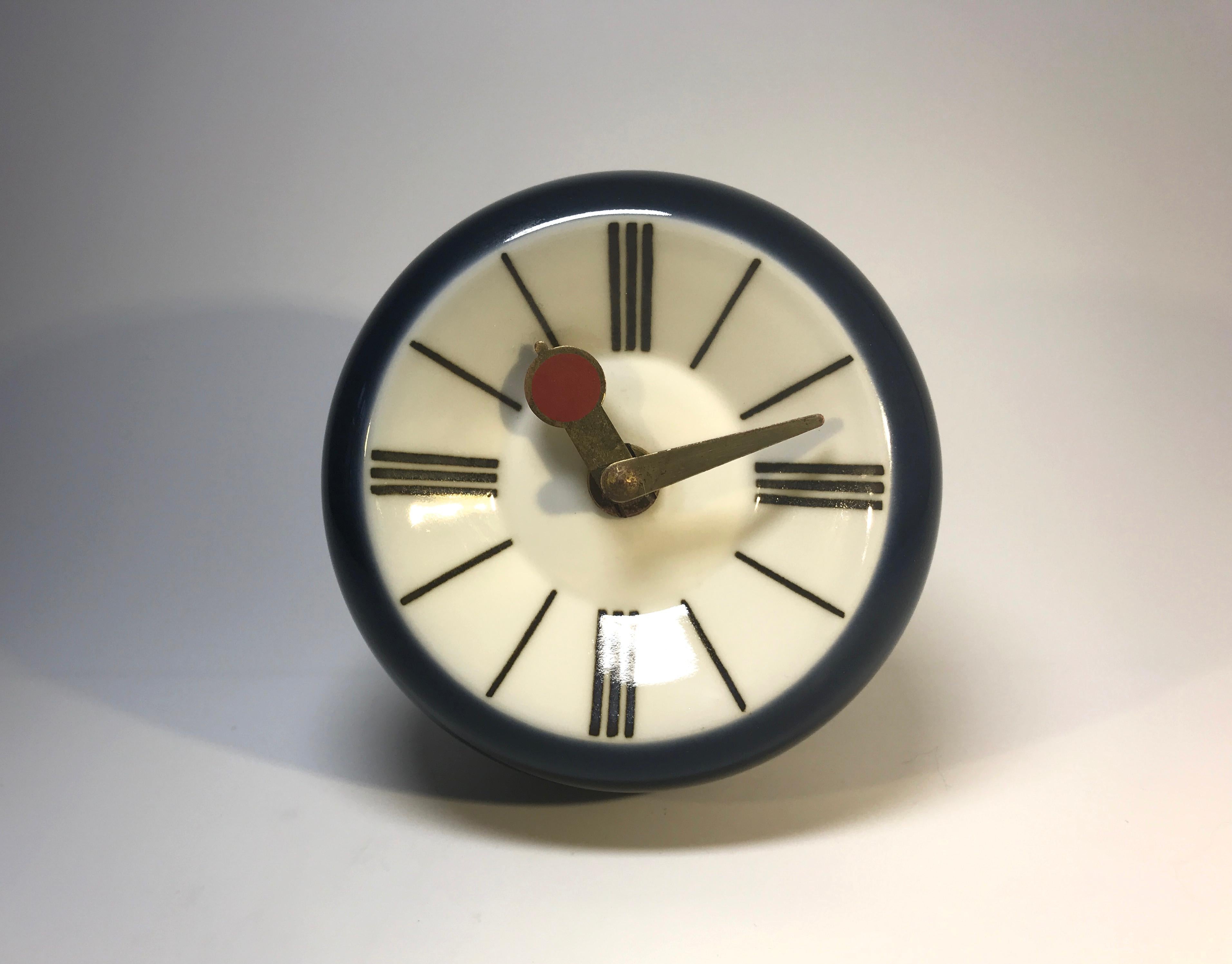 Superb design from the 1970s by Snorre Læssøe Stephensen for Royal Copenhagen. Navy blue porcelain battery operated wall clock. Hands are brass with red enamel to the hour hand.
Fully working battery mechanism.
Danish understated design at its