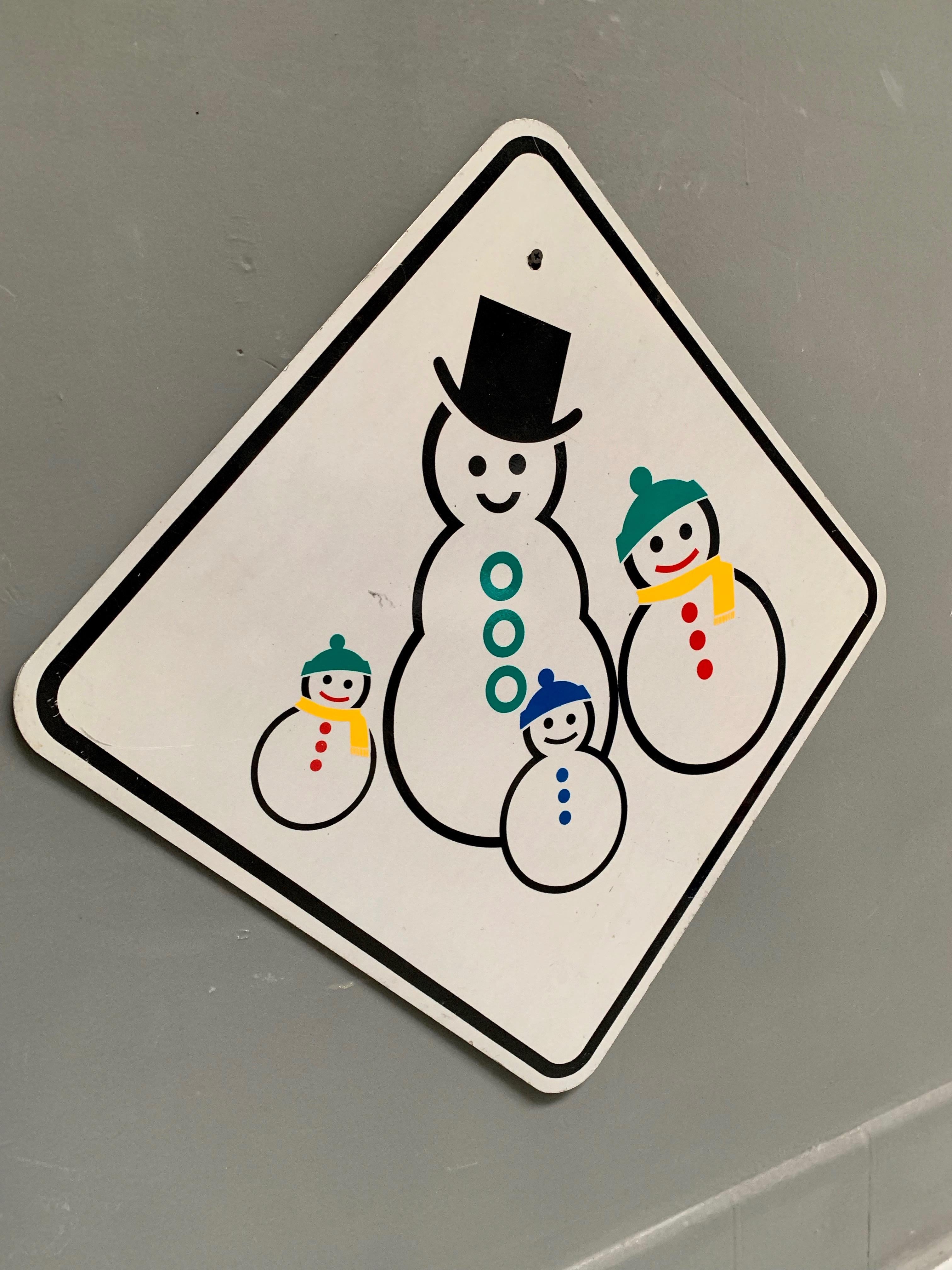 Very unique California street sign depicting a family of Snow men. Two adults and two children. Steel sign in great condition with great coloring. Cool piece of holiday decor.