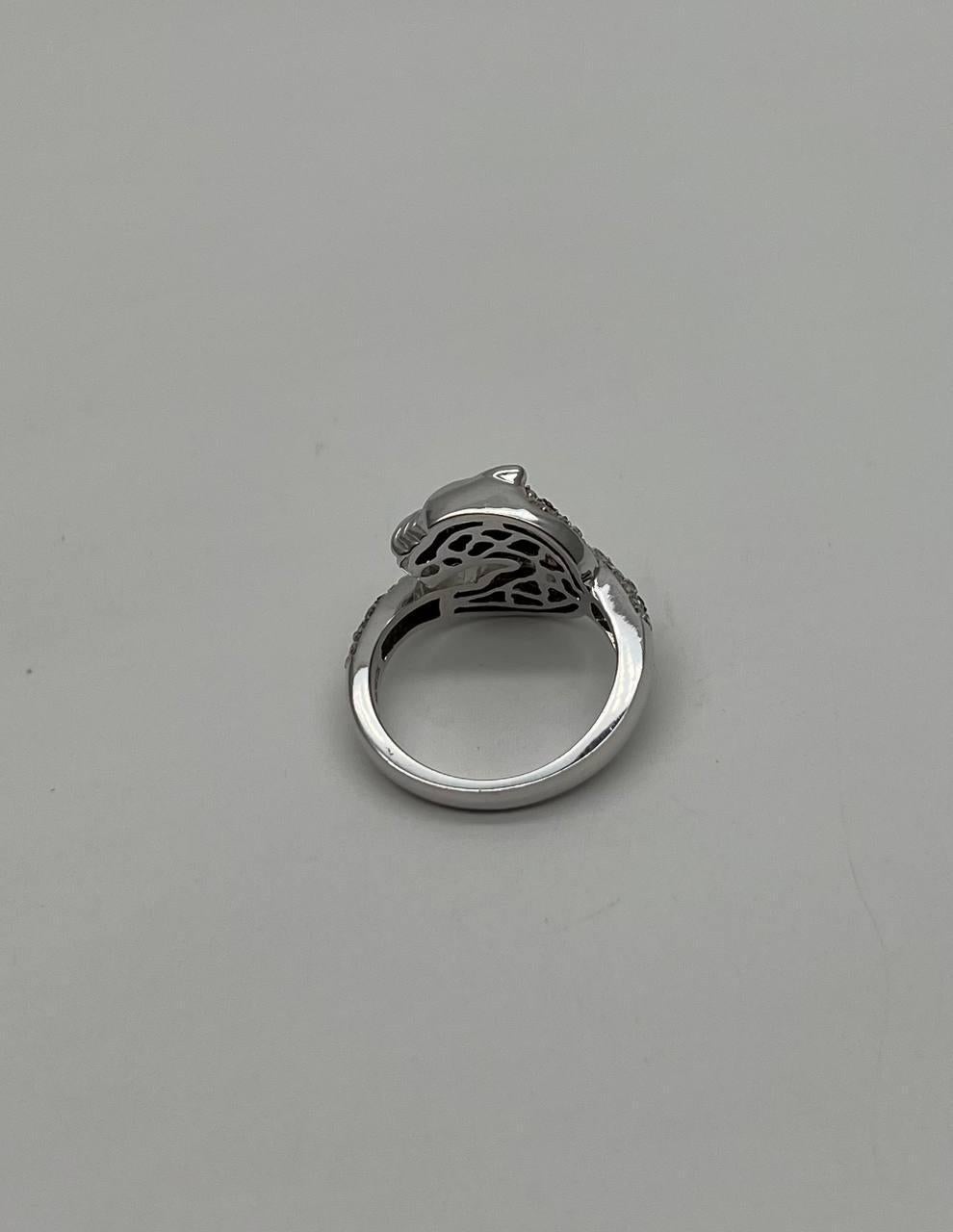 This captivating piece features a sleek design in polished metal, adorned with intricate detailing that adds a touch of sophistication. The ring's surface is embellished with shimmering stones, creating a harmonious blend of texture and sparkle.
The