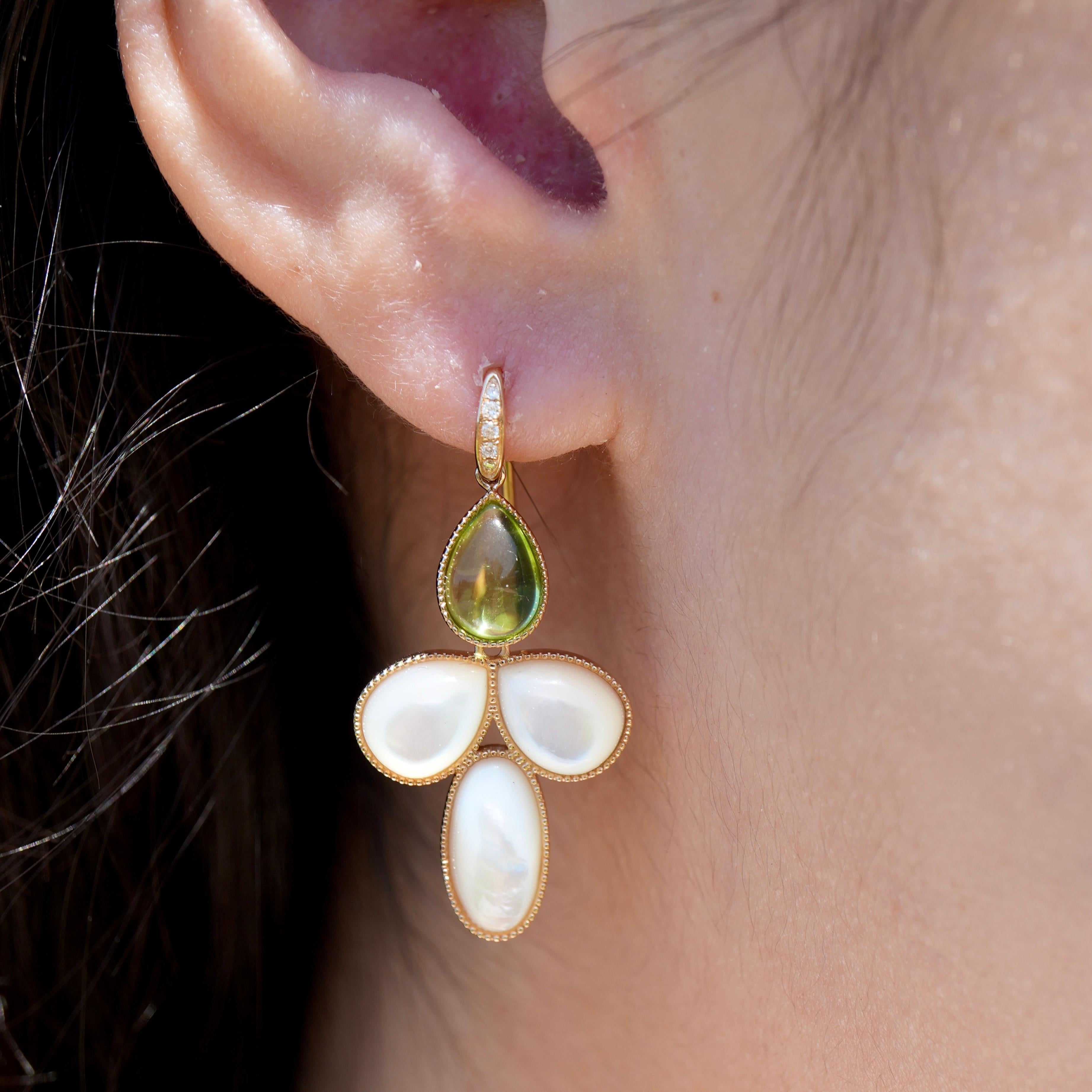 Drawing inspiration from the quiet poetry of snowfall and first blossoms, the SnowDrop earrings feature smooth cabochons of  14 ct natural peridot and mother of pearl in a graceful, petal-like arrangement. The gentle contrast between the translucent