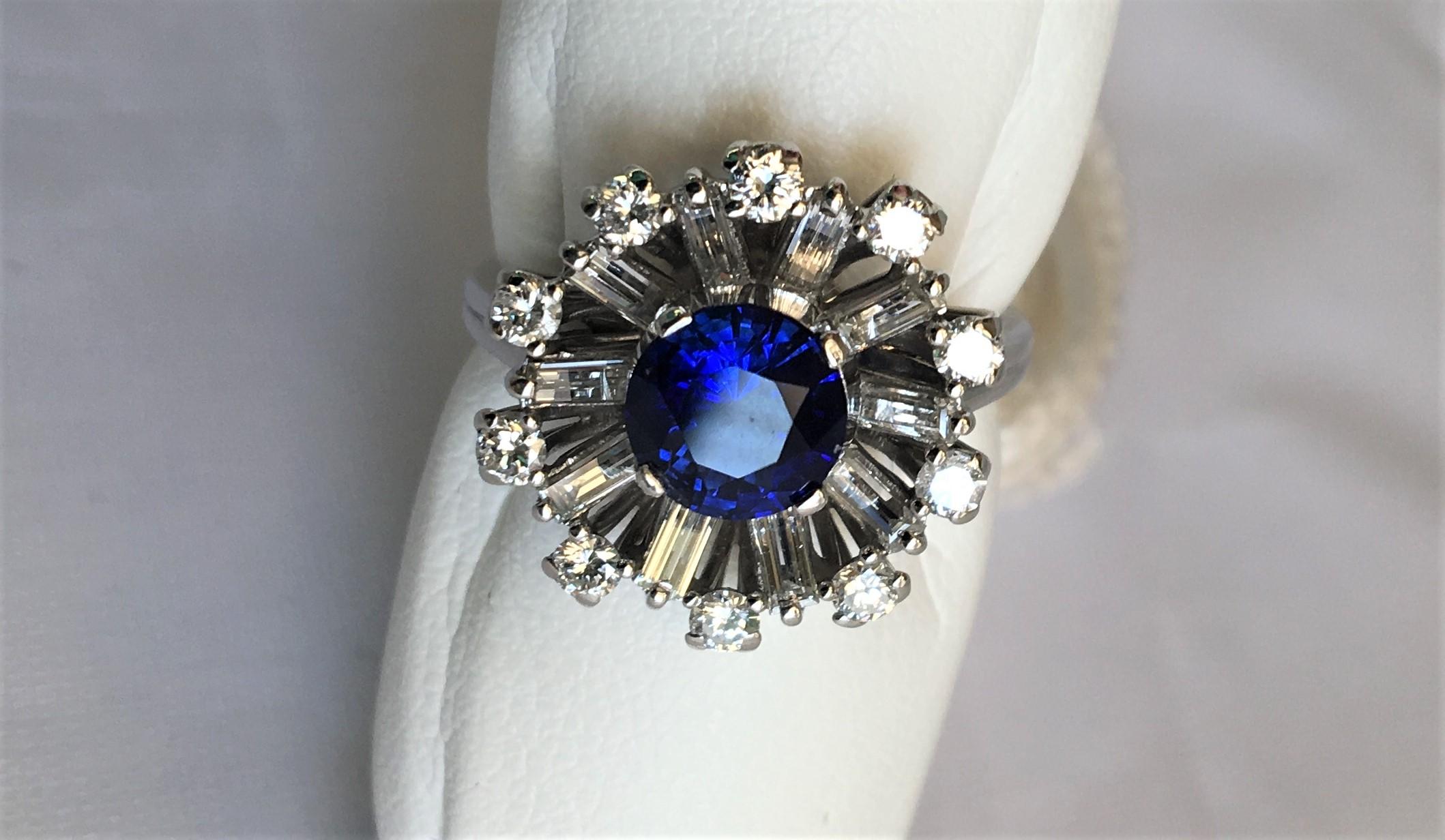 Unique vintage Cocktail Ring
Center blue sapphire with diamond halo
1.26 carat center blue sapphire, approximately 6.5mm round, outstanding color
20 diamonds (10 round and 10 baguettes), approximately 1.00 carat total diamond weight, F-G color, VS